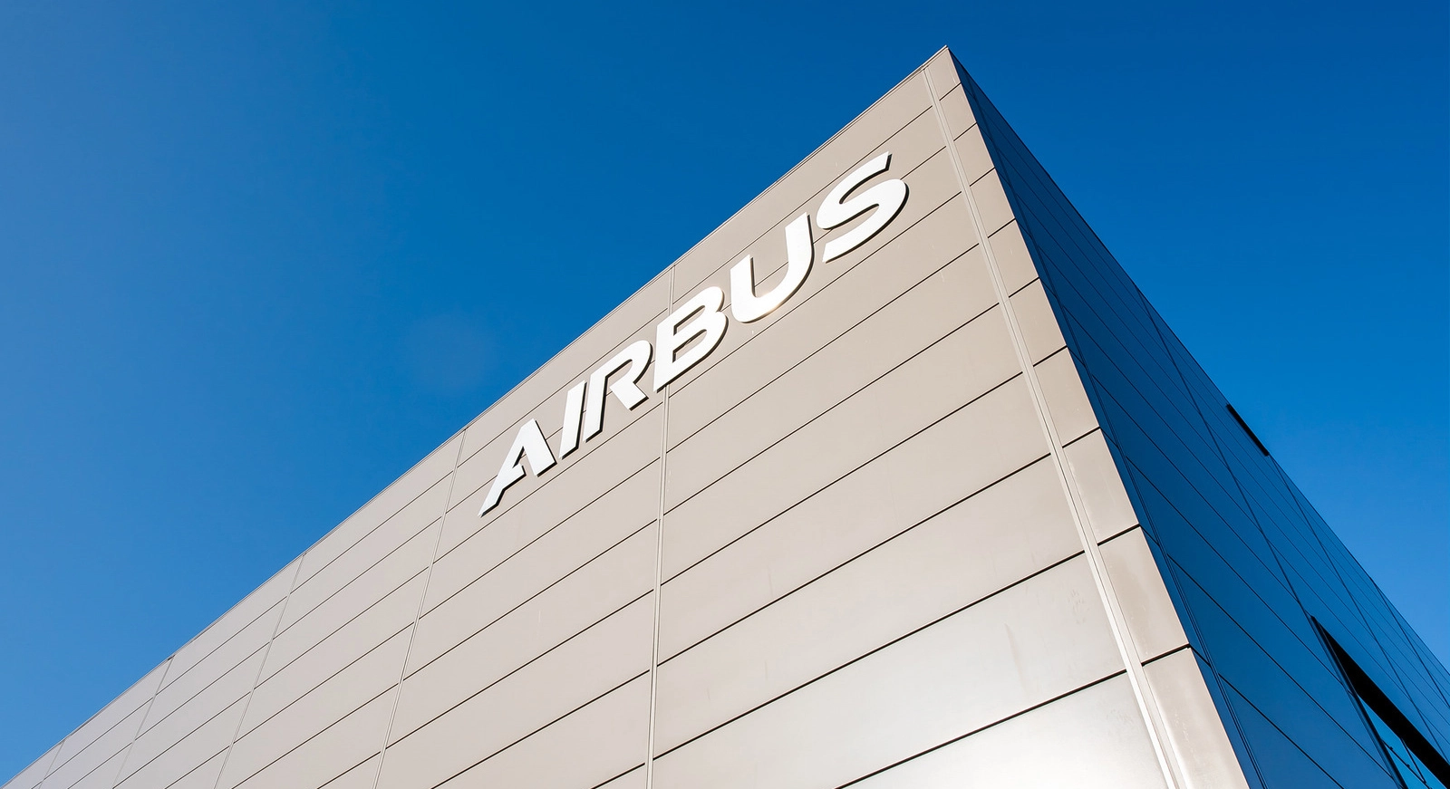 Exterior view of an Airbus building with a clear blue sky.