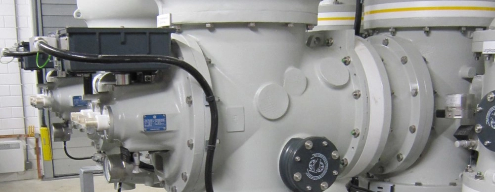 Large industrial machinery with complex components in a warehouse setting.