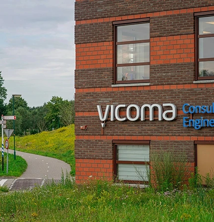Exterior view of the Vicoma Consulting Engineering building in Sint Oedenrode, near a paved path and greenery.