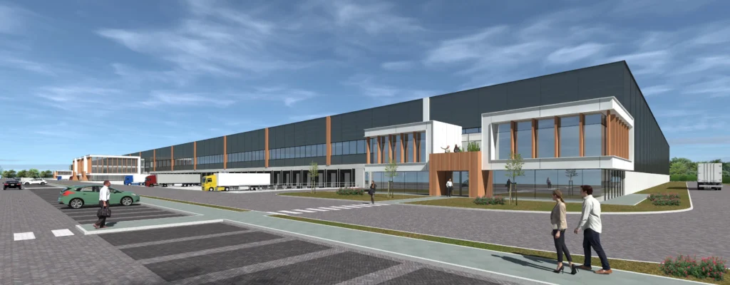 A modern industrial warehouse with a parking area and loading docks, set against a clear blue sky.
