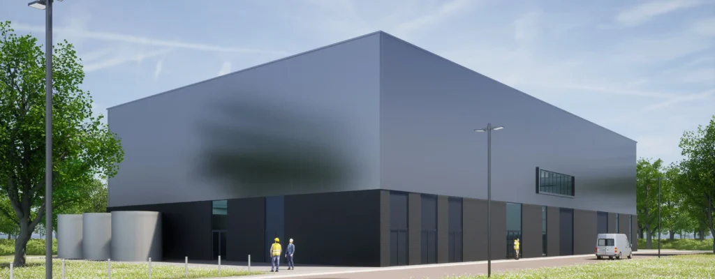 Modern industrial building with two people in hard hats and a van nearby, surrounded by greenery.
